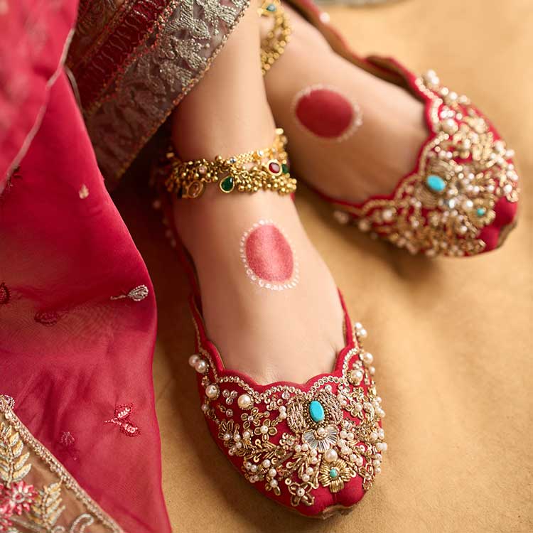 Embroidered red khussa shoes with pearls and turquoise accents for women, traditional festive wear
